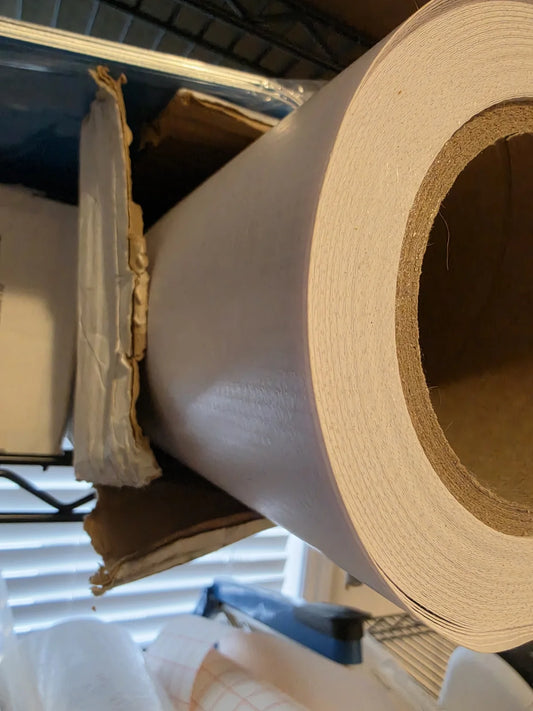 Close view of a white adhesive label stock roll