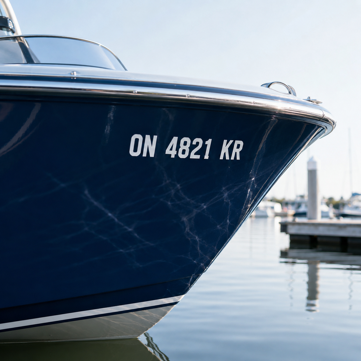 Illustrated preview of a matched white boat number pair shown on both sides of a dark blue bow at a marina