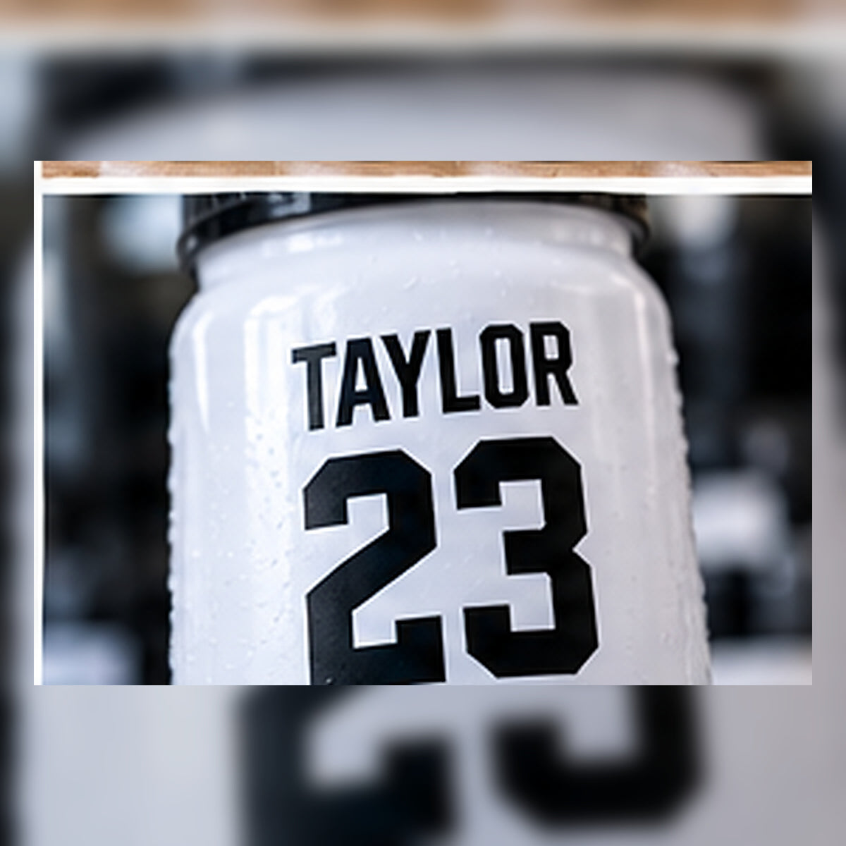 Close-up of a personalized player name and number on a bottle.
