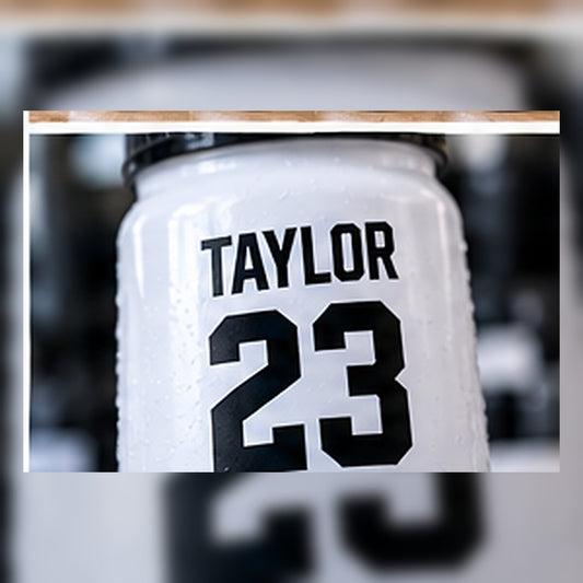Close-up of a personalized player name and number on a bottle.