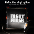 Reflective custom text decal illuminated on a trailer at night