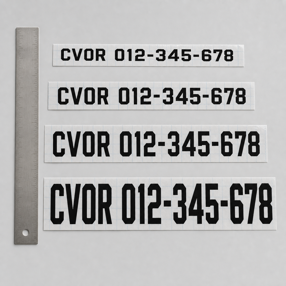 Four CVOR number-only cut-vinyl samples showing the available character-height range