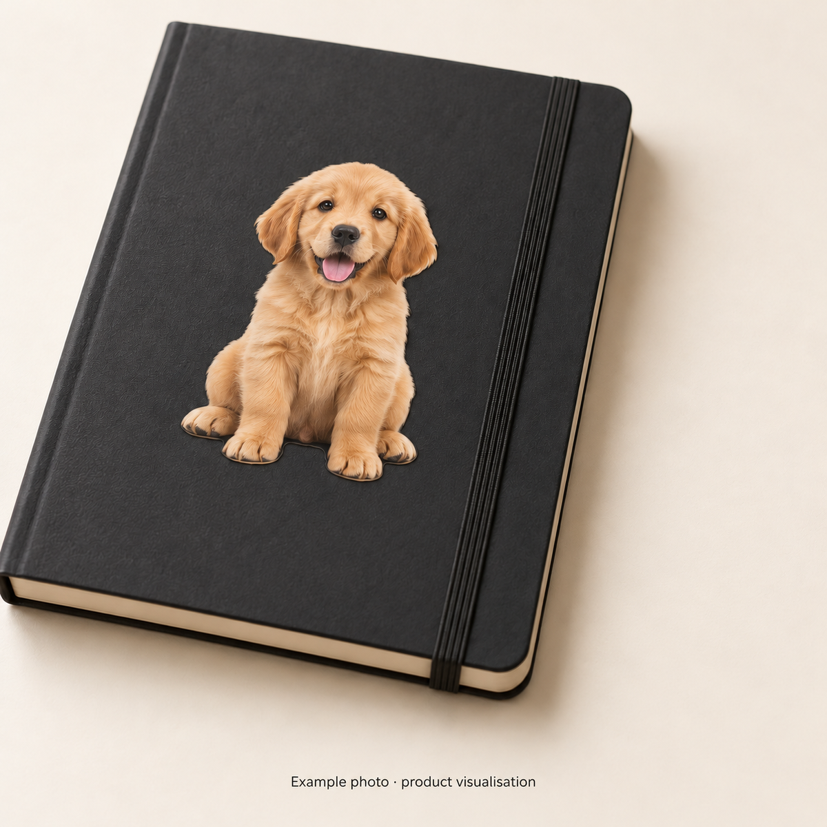Product visualisation of a synthetic puppy photo reproduced as a contour-cut sticker on a dark notebook; notebook not included.