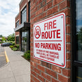 Compliance sign installed on an exterior brick wall