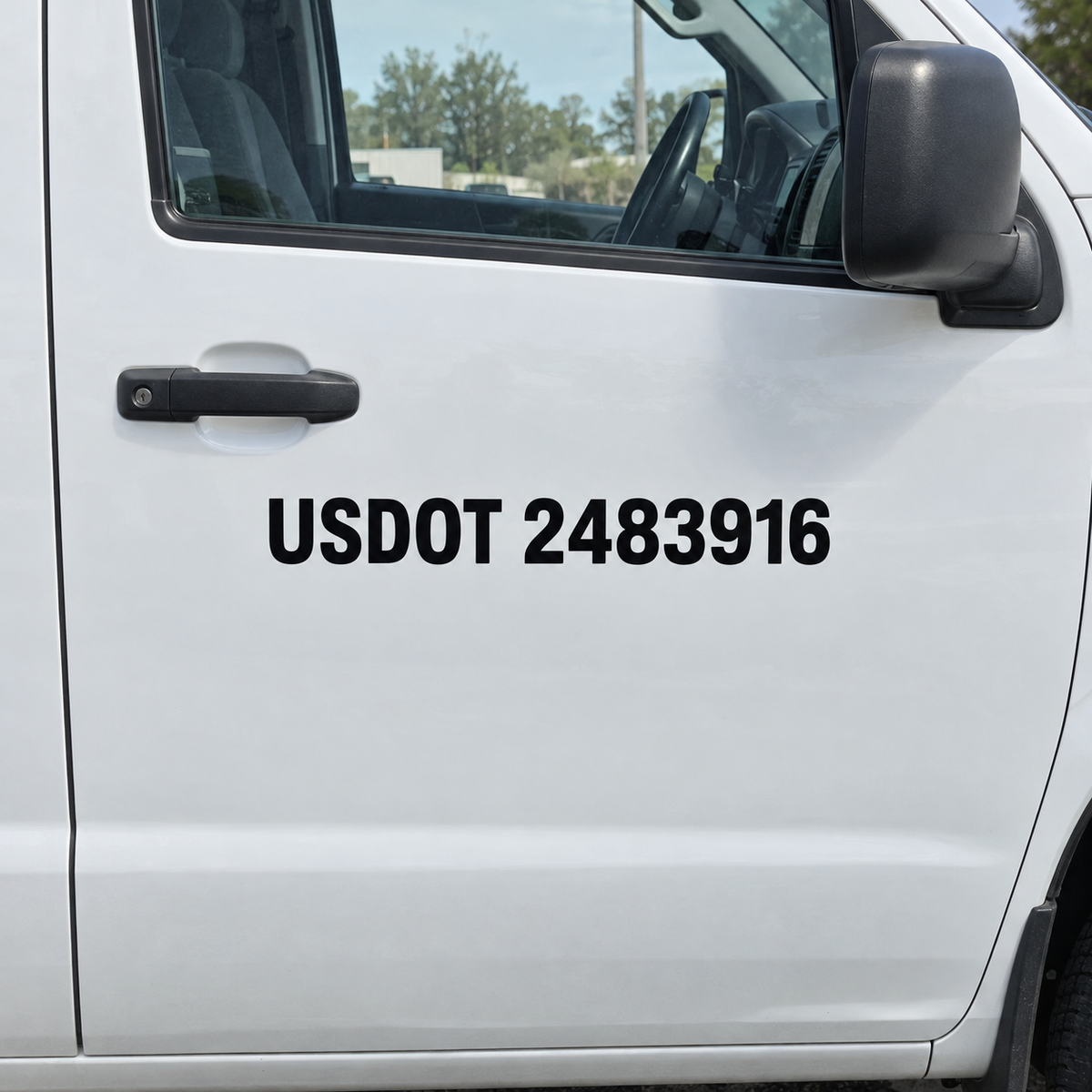 Black USDOT 2483916 vinyl lettering on the passenger door of a plain white work van, clear of the handle and seam.