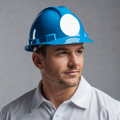 Worker wearing a blue hard hat with a blank white circular sticker on the front