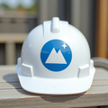 White hard hat with a round blue mountain icon sticker
