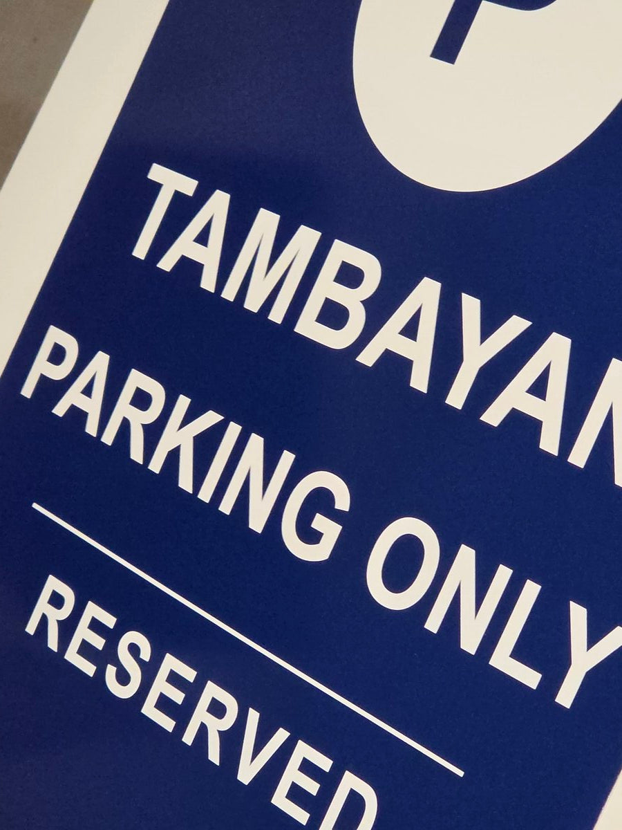 Close-up of custom parking sign showing professional vinyl print quality and rounded corners