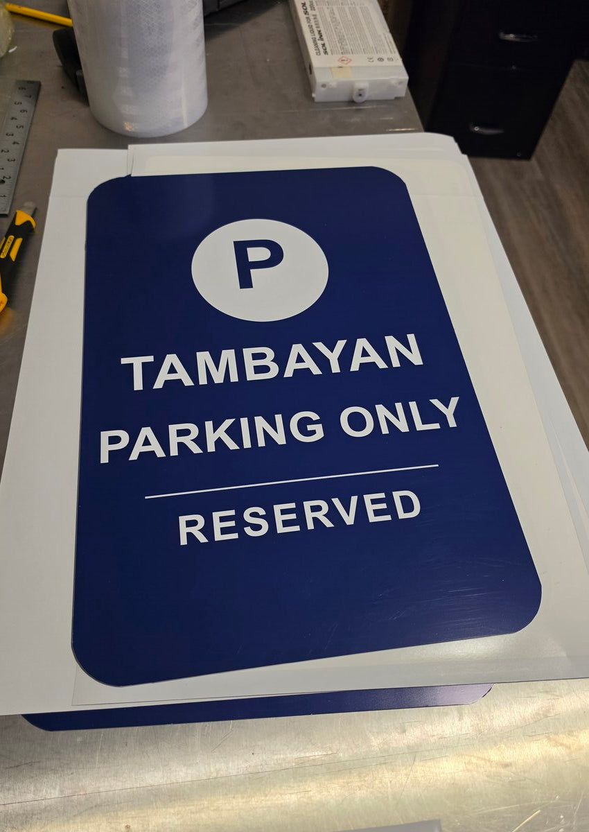 Custom reserved parking sign printed on durable vinyl — navy blue with white text and parking icon made in Ontario