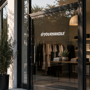 Business handle decal on modern boutique storefront window