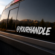 Close-up of custom handle vinyl decal on tinted truck glass