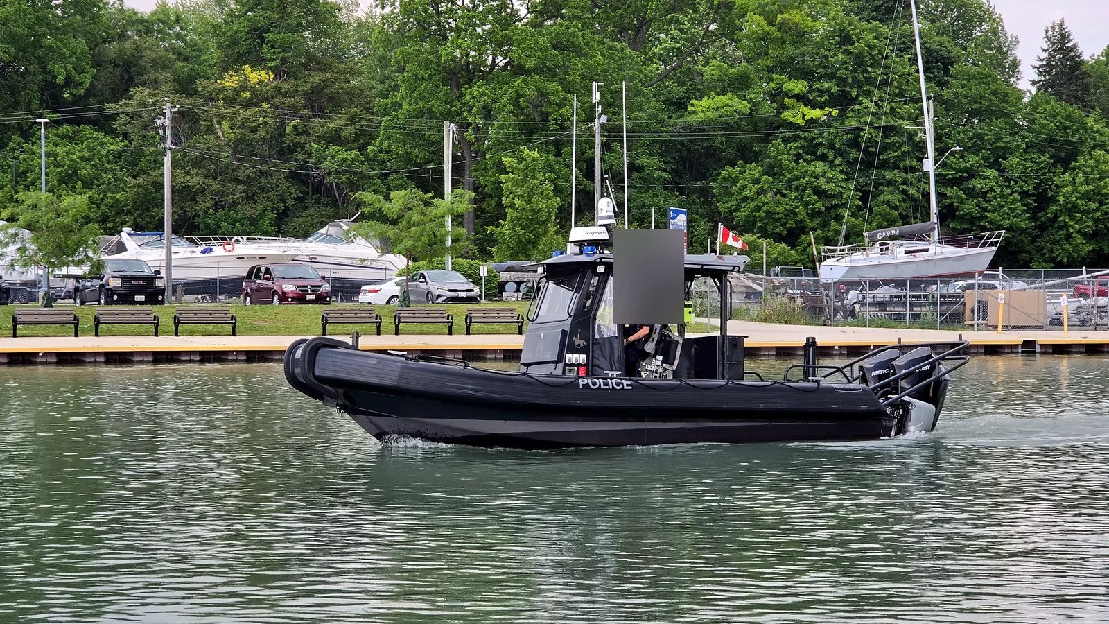 Ontario marine police patrol boat on enforcement patrol in Port Dalhousie harbour — display your Transport Canada registration legally.