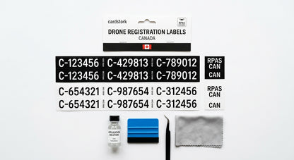 Drone registration labels applied to a black quadcopter frame