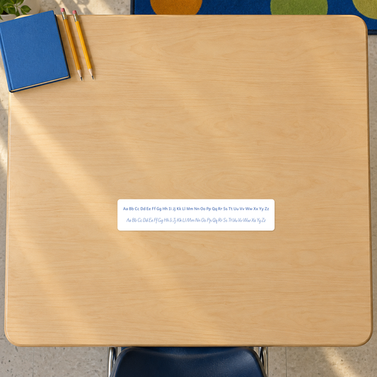 Ready-made classroom alphabet reference sticker, complete print and cursive Aa to Zz,10x2in — installed on a classroom desk