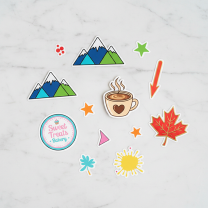 Custom die-cut vinyl stickers on a work surface